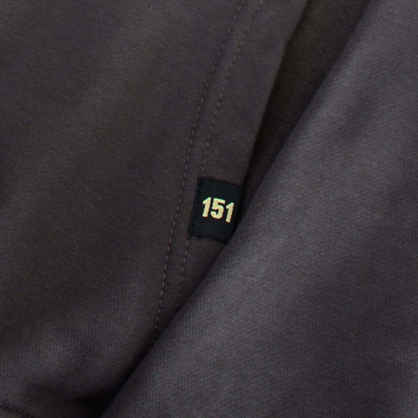 Close-up of a dark gray fabric with a '151' label.