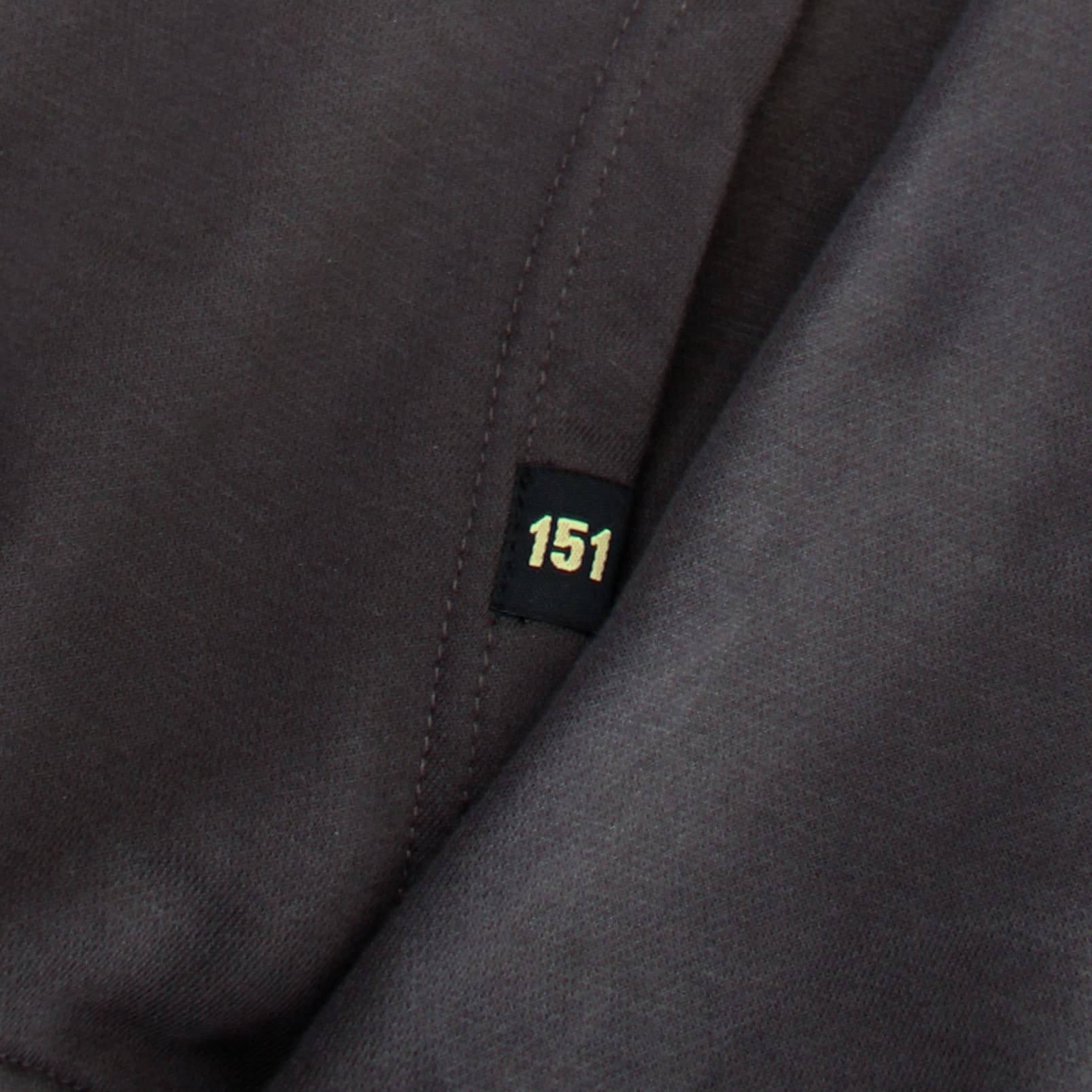 Close-up of a dark gray fabric with a '151' label.