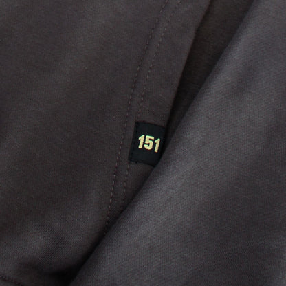 Close-up of a dark gray fabric with a '151' label.